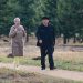 Happy senior couple strolling along a park path on a pleasant spring day.